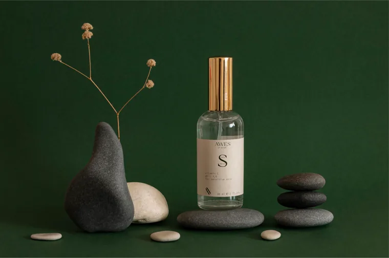 Awes of Nature: glass mist bottle, stones and dried stems on deep green