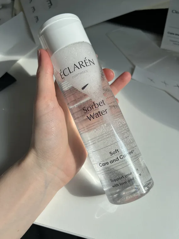 Éclarén: the finished Sorbet Water bottle held in one hand, cut sheets on the table behind it