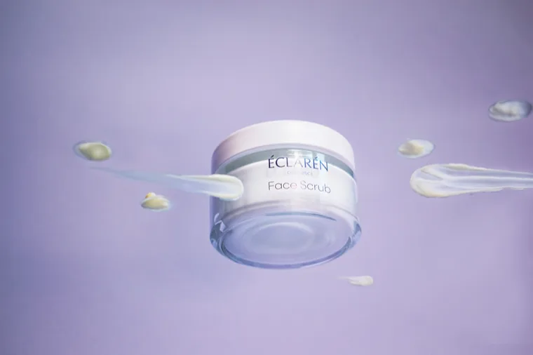 Éclarén: the Face Scrub jar floating, smears of product suspended around it