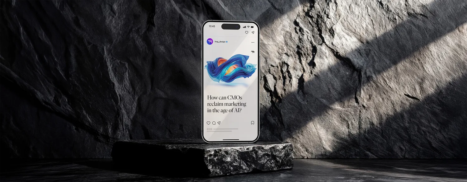 The CMO Playbook opening post on a phone, stood on a stone plinth